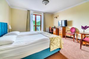 Postel nebo postele na pokoji v ubytování Hotel Pan Tadeusz