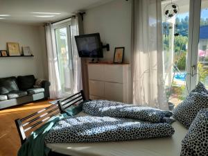 a living room with a bed with pillows on it at Löwensteiner Berge in Löwenstein