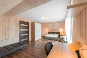 a bedroom with a bed and a table in a room at Shanghai Banzai Family Apartment Vilnius in Vilnius