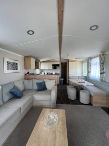 a living room with a couch and a table at Sunnycott Caravan Park in Cowes