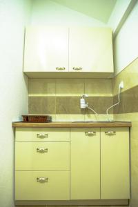 a kitchen with white cabinets and a counter at Villa Silva in Ohrid