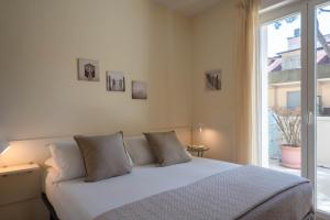 a bedroom with a white bed and a window at Residence Capitol in Cattolica +82 photos