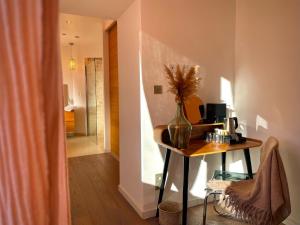 a room with a table and a vase with flowers in it at Maï Homes - La Villa Bompard in Marseille