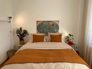 a bedroom with a bed with a painting on the wall at Maï Homes - La Villa Bompard in Marseille