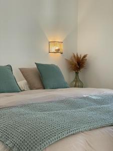 a bedroom with a bed with green pillows at Maï Homes - La Villa Bompard in Marseille