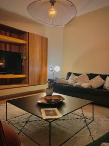 a living room with a couch and a coffee table at Maï Homes - La Villa Bompard in Marseille