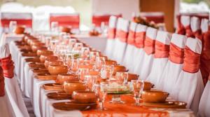 a long table with plates and wine glasses on it at Áldos Panzió in Farád