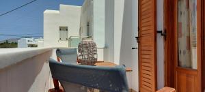 a balcony with a table and a chair and a vase at Apartments Anna Maria in Agia Anna Naxos