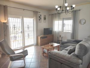 a living room with a couch and a tv at Casa rural Villa Miradri in Torrox
