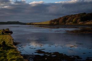 a view of a river with a cloudy sky at Skeabost House Hotel in Portree