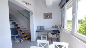 a room with a table and chairs and a staircase at Pipo Apartment Mareda in Novigrad Istria