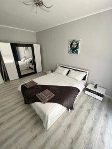 a bedroom with a large bed and a mirror at TM Panorama Beach Apartments in Nesebar +24 photos