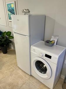 a white refrigerator and a washing machine in a room at TM Panorama Beach Apartments in Nesebar
