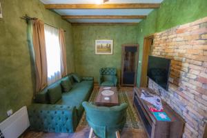 a living room with a couch and a table at Etno Selo Svodje in Vlasotince