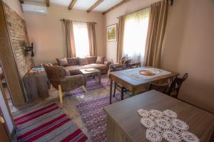a living room with a couch and a table at Etno Selo Svodje in Vlasotince
