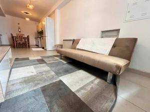 a couch in a living room with a kitchen at Casa de Santa Maria 113 in Castelo Branco +5 photos