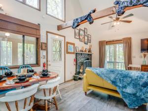 a living room with a dining table and a yellow couch at Elmwood Elmwood Escape A Cozy Retreat at The Hideout in Hamlin