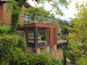 a glass house on top of a building at Seefels Appartements in Döbriach