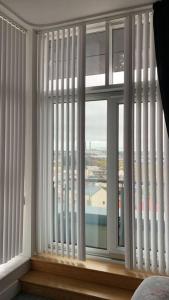 a room with a large window with white blinds at 3 Bedroom Penthouse Apartment in larne in Larne