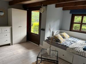 a bedroom with a bed and a vase on a table at Wiejski Chill in Męcikał