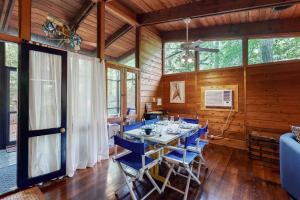 a dining room with a table and blue chairs at Middlesex Beach -- 9 Errett in South Bethany