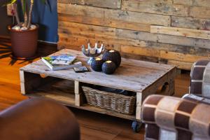 a wooden coffee table with vases on top of it at Modern Shabby Chic Apartment in Durbanville