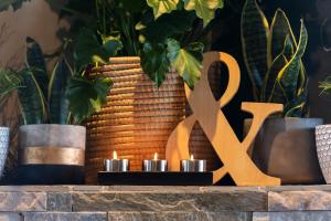a table with two candles and a large gold sign at Modern Shabby Chic Apartment in Durbanville