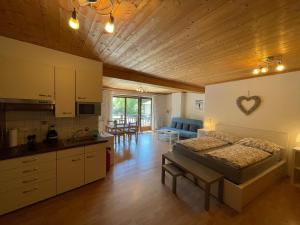 a large room with a bed and a kitchen with a kitchen at City-apart Kitzbühel Stadt in Kitzbühel