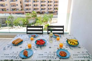 a table with plates of food and fruit on it at Ocean Garden Beautiful FREE WIFI in Playa Paraiso