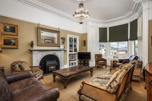 a living room filled with furniture and a fireplace at Annfield House, Callander in Callander