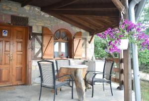 a patio with a table and chairs and a building at Mountain House Kastro in Kástron