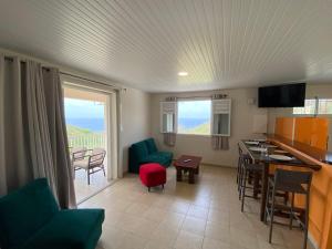 a living room with a kitchen and a dining room at Locations Morne aux Vents in Fond Boucher
