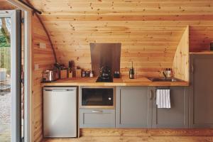 a kitchen in a tiny house with wooden walls at Hidden Orchard in Chester
