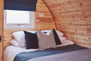 a bedroom with a bed with a wooden wall at Hidden Orchard in Chester