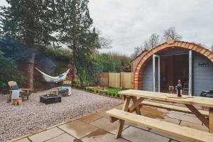 a backyard with a picnic table and a tent at Hidden Orchard in Chester +9 photos