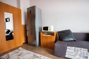 a room with a refrigerator and a bed and a microwave at Casa Riana in Turda