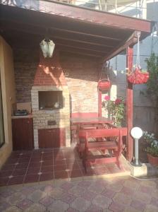 a patio with a table and a brick fireplace at Villa Mars in Sunny Beach