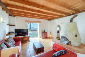 a living room with a couch and a fireplace at Lanzahost Finca Mojon in El Mojón