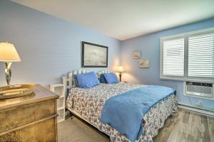 ブリゲンティーンにあるFirst-Floor Brigantine Condo Steps to Ocean!の青い壁と窓のあるベッドのある寝室