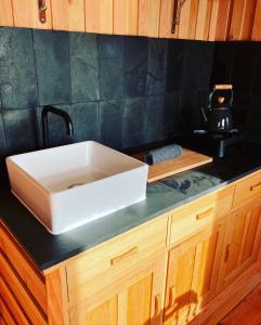 a white sink on top of a counter at Shepherds Hut in a private meadow with sea views in Hartland