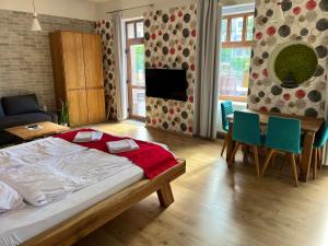 a bedroom with a bed and a table and chairs at Terrace Apartman Prémium Belváros Jacuzzival in Veszprém