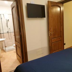 a bedroom with a bed and a television on a wall at Residence l'Incanto in Piano di Sorrento +94 photos