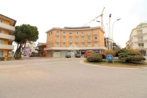 a large building in the middle of a street at AMPIO BILOCALE Caorle LUNGOMARE LEVANTE in Caorle +10 photos