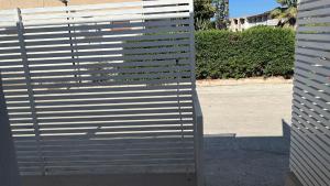 a large metal fence on the side of a street at House Relax Marzamemi in Noto +3 photos