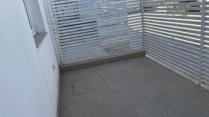 a room with blinds on a window with a tile floor at House Relax Marzamemi in Noto
