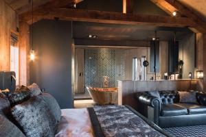 a bedroom with a couch and a tub in a room at Ramside Hall Hotel, Golf & Spa in Durham
