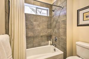 a bathroom with a bath tub and a toilet at Sun-Soaked Waikoloa Retreat with Private Lanai! in Waikoloa +34 photos