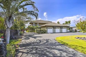 a house with a palm tree and a driveway at Sun-Soaked Waikoloa Retreat with Private Lanai! in Waikoloa