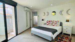 a bedroom with a bed and a large window at Strip by Check-in Portugal in Albufeira