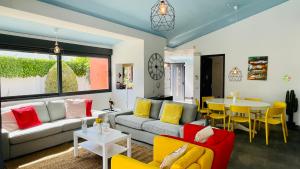 a living room with a couch and a table at Strip - Private Pool - 12 Guests - Albufeira in Albufeira